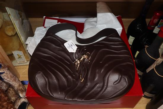 A Cartier Panthere textured brown leather shoulder bag, with signature gold-toned panther decoration to front